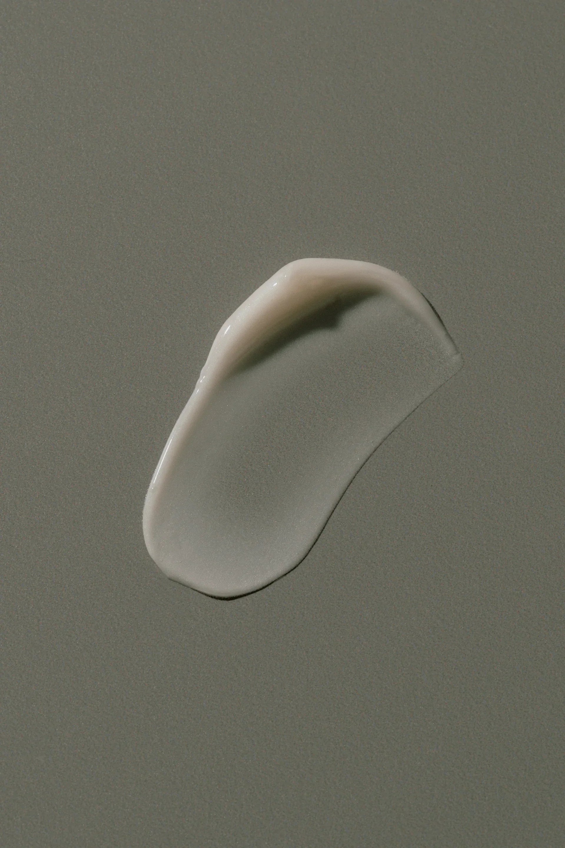 Smooth cream swatch on neutral background, showcasing hydrating skincare texture